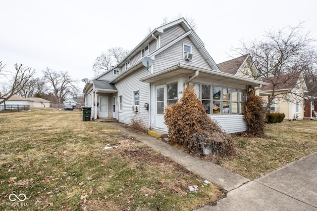 view of front of property with entry steps, a front lawn, and cooling unit