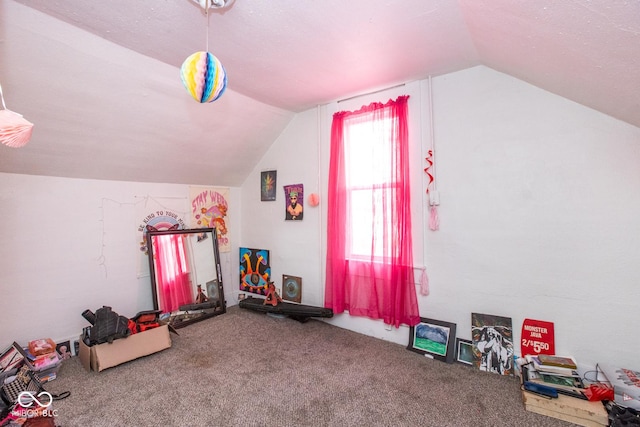 game room with vaulted ceiling and carpet flooring