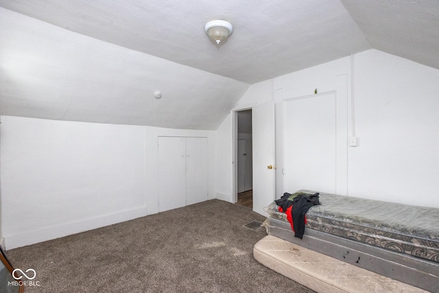 additional living space with lofted ceiling and carpet flooring