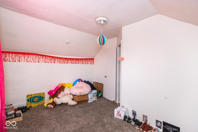 recreation room featuring carpet floors and vaulted ceiling