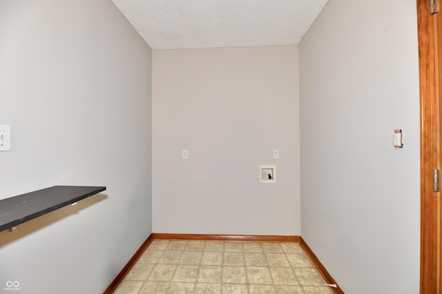 empty room featuring baseboards, a textured ceiling, and light floors