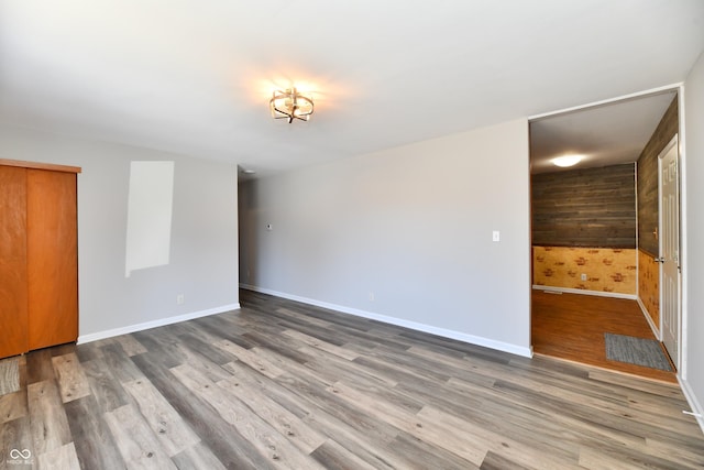 empty room with baseboards and wood finished floors