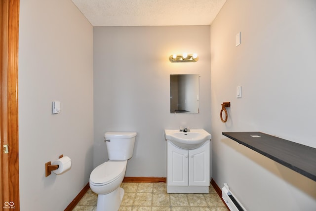 bathroom featuring baseboards, toilet, baseboard heating, a textured ceiling, and vanity