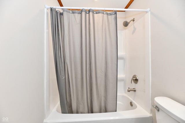 full bath with toilet and shower / tub combo with curtain