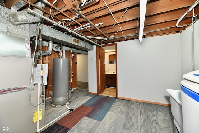 unfinished basement with gas water heater, visible vents, and heating unit