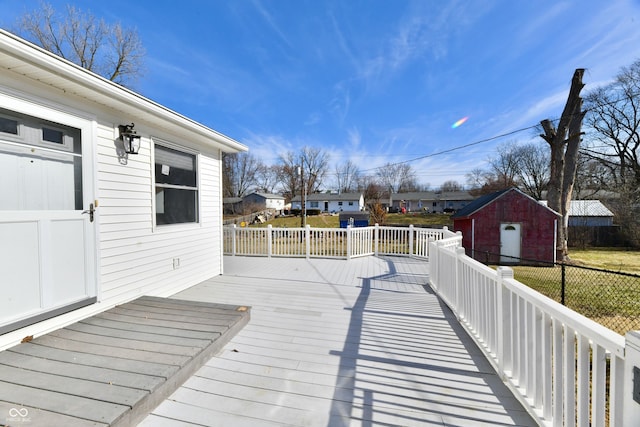 deck with an outbuilding, a shed, and a residential view