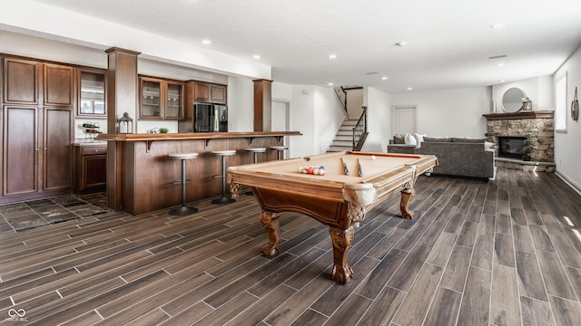 game room with recessed lighting, a fireplace, billiards, bar area, and wood tiled floor