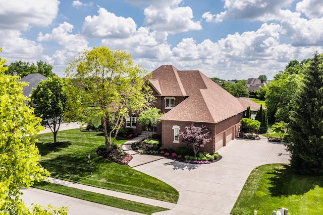 view of front facade featuring a garage, brick siding, driveway, roof with shingles, and a front yard