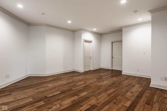 spare room featuring ornamental molding, recessed lighting, dark wood-style flooring, and baseboards