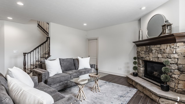 living area featuring stairway, a fireplace, wood finished floors, and recessed lighting