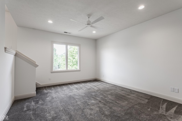 unfurnished living room featuring baseboards, visible vents, dark colored carpet, and recessed lighting