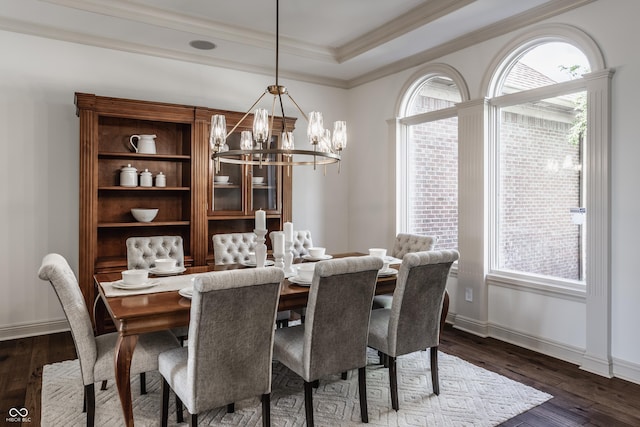 dining area with dark wood-style floors, crown molding, a raised ceiling, and a chandelier