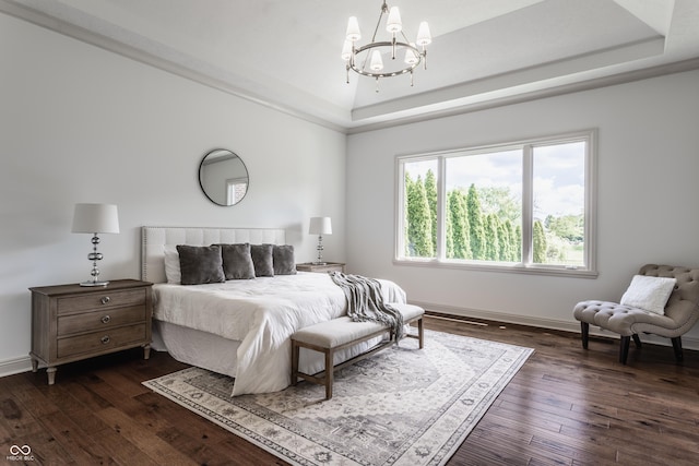 bedroom featuring a raised ceiling, a notable chandelier, dark wood finished floors, and baseboards