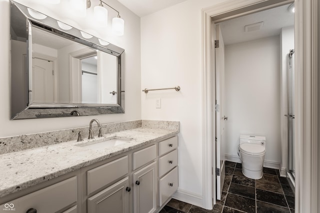 full bathroom featuring toilet, visible vents, vanity, baseboards, and stone finish flooring