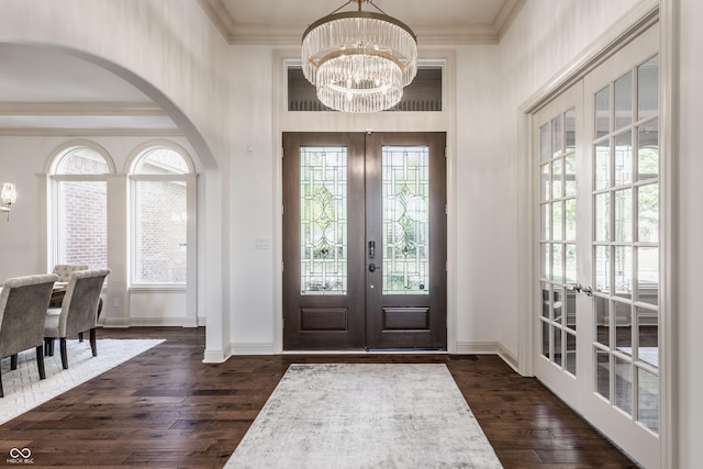 entryway featuring a chandelier, french doors, and crown molding