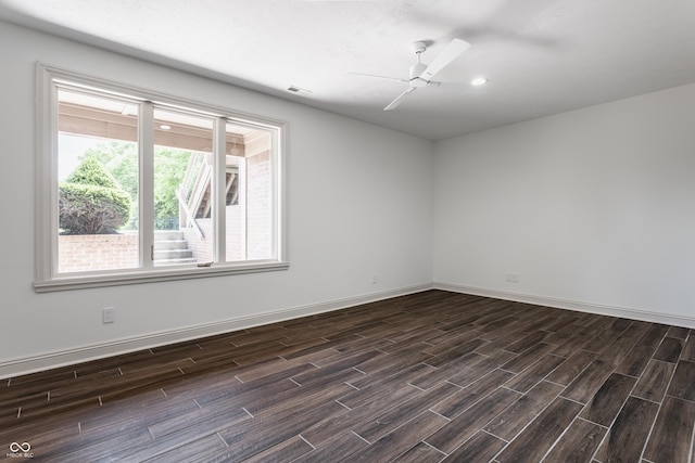 unfurnished room with ceiling fan, wood finish floors, visible vents, and baseboards