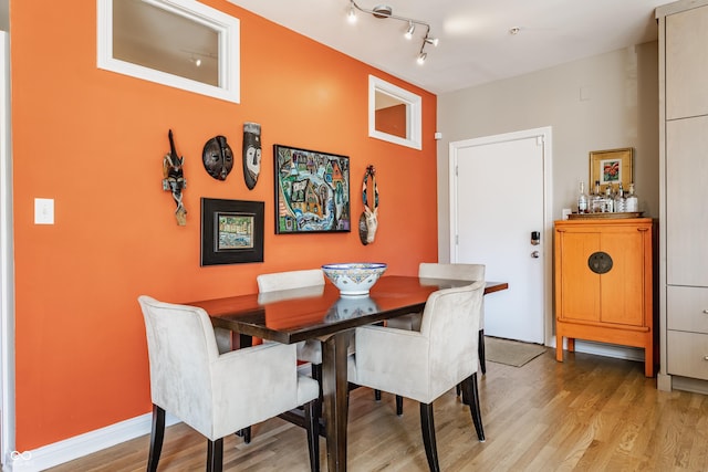 dining room featuring baseboards and light wood-style floors