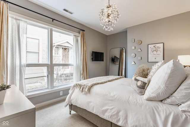 bedroom with visible vents, light carpet, multiple windows, and a notable chandelier