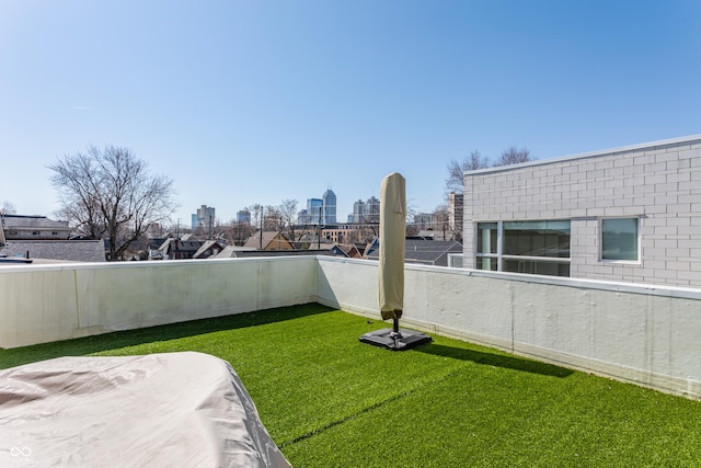 view of yard featuring a balcony and a city view