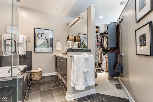 full bath with tile patterned flooring, visible vents, a shower stall, baseboards, and vanity