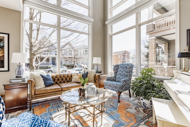 living area featuring a wealth of natural light and a high ceiling