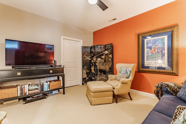 carpeted living room with visible vents, a ceiling fan, and baseboards