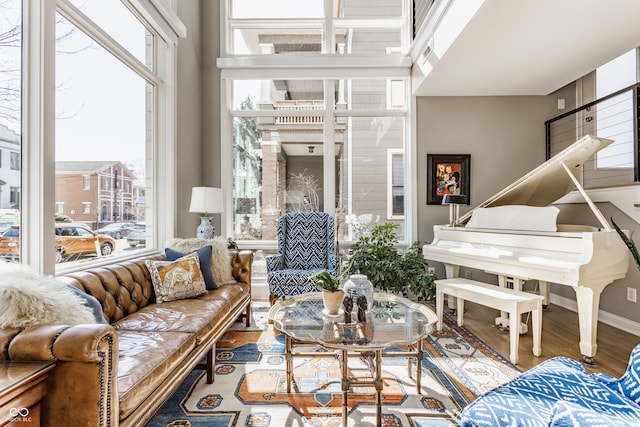 living area with baseboards and wood finished floors