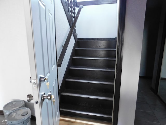 staircase with tile patterned floors