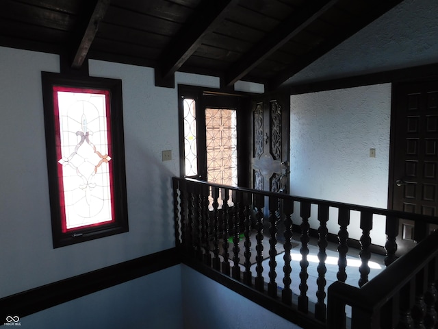 interior space with vaulted ceiling with beams, wooden ceiling, and a wealth of natural light