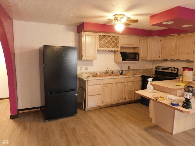 kitchen with light countertops, electric range, light wood-style flooring, freestanding refrigerator, and a sink