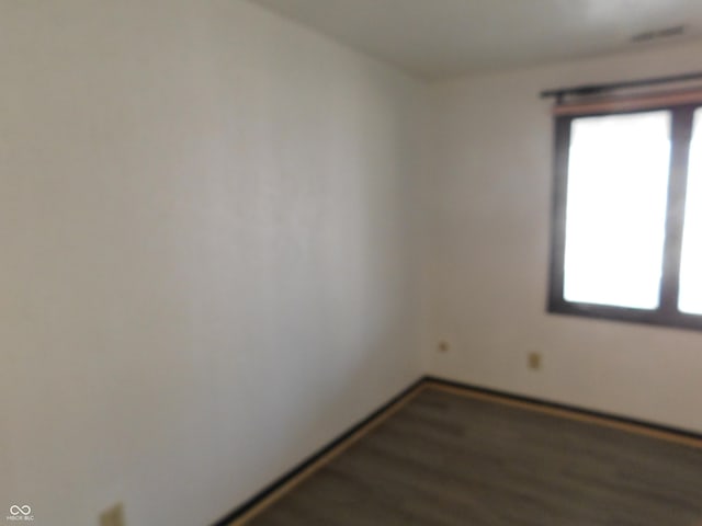 spare room with wood finished floors