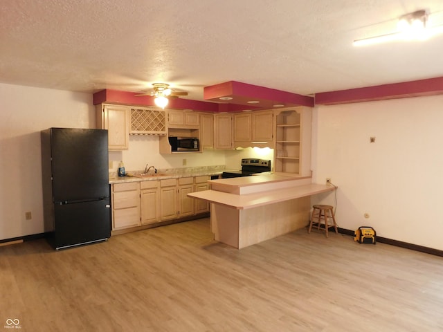 kitchen featuring stainless steel electric range oven, light countertops, freestanding refrigerator, and light wood-style floors