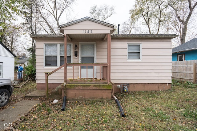 bungalow-style house with fence