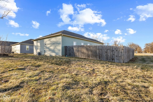 view of property exterior featuring cooling unit and fence