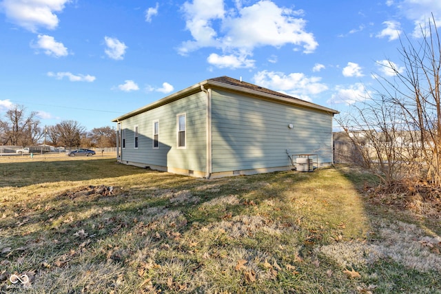 view of home's exterior with crawl space and a yard