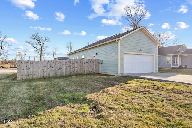 view of property exterior with driveway, a garage, fence, and a yard