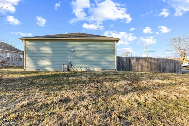 back of property featuring central AC, a yard, crawl space, and fence