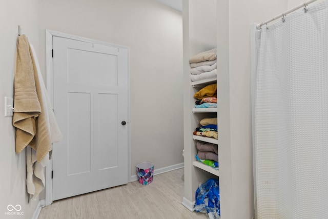 interior space featuring light wood finished floors and baseboards