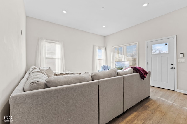 living area featuring light wood finished floors, plenty of natural light, and recessed lighting