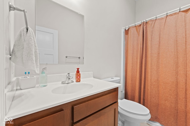 full bathroom featuring curtained shower, vanity, and toilet