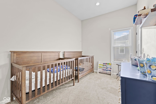 bedroom featuring a crib, baseboards, carpet flooring, and recessed lighting