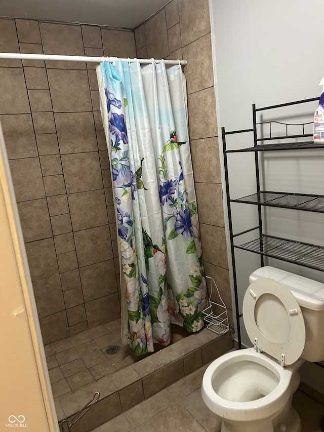 bathroom featuring a shower stall and toilet