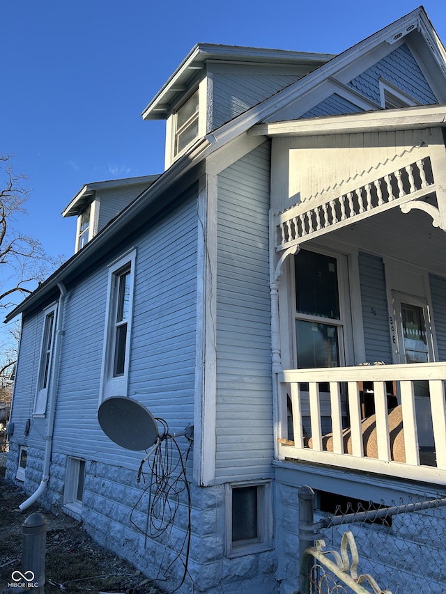 view of side of property featuring a porch