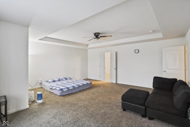 bedroom with ceiling fan, carpet, a raised ceiling, and baseboards