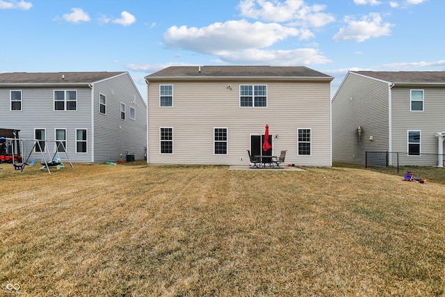 back of house featuring a patio, a lawn, and fence