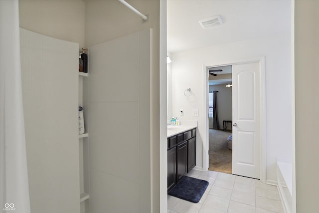 bathroom featuring visible vents, a bath, vanity, and tile patterned floors