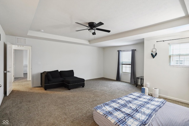 interior space featuring visible vents, multiple windows, and a tray ceiling