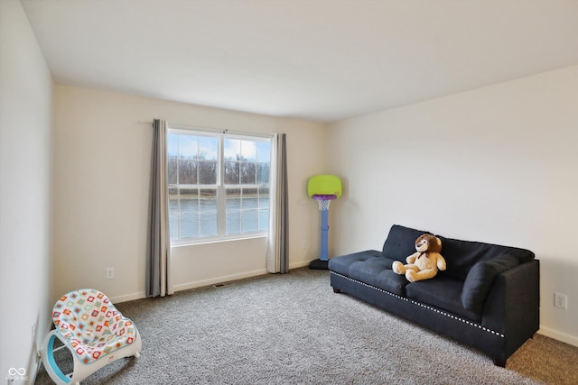 sitting room with baseboards and carpet flooring