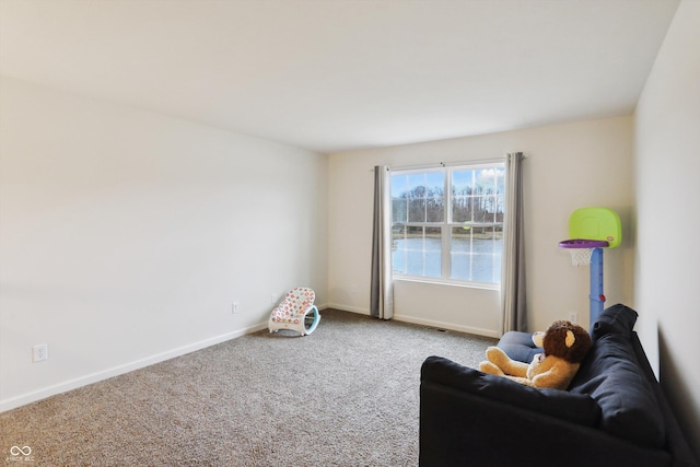 living area featuring carpet floors and baseboards