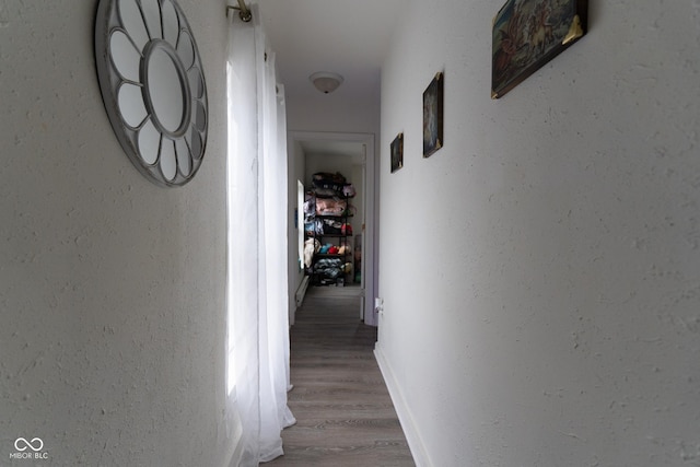 238-240 N Beville Ave, Indianapolis, IN 46201 - hallway featuring a textured wall, wood finished floors, and baseboards